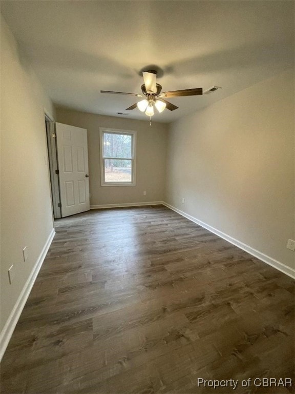 unfurnished room with ceiling fan and dark wood-type flooring