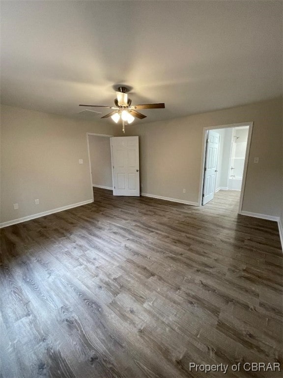 spare room featuring ceiling fan and dark hardwood / wood-style flooring