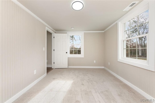 empty room with light colored carpet and ornamental molding