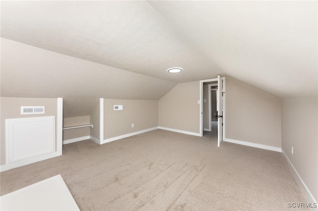 bonus room featuring light colored carpet and vaulted ceiling