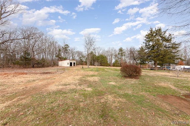 view of yard featuring an outbuilding and a rural view