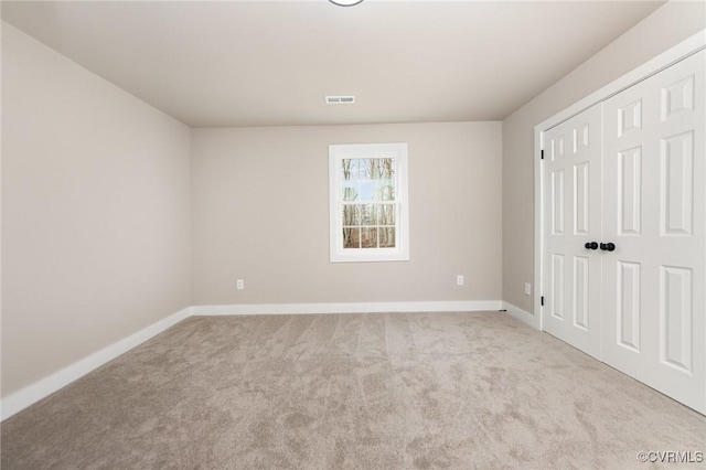 unfurnished bedroom featuring light colored carpet