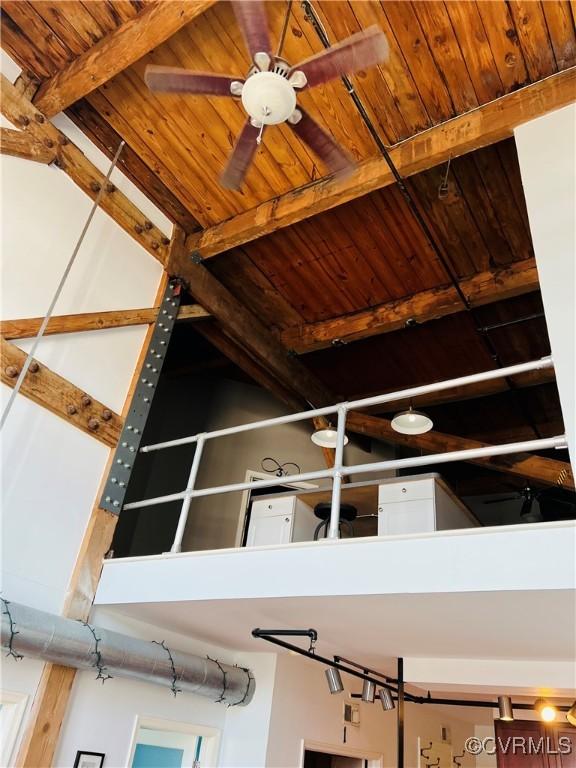 room details with beamed ceiling, ceiling fan, and wood ceiling