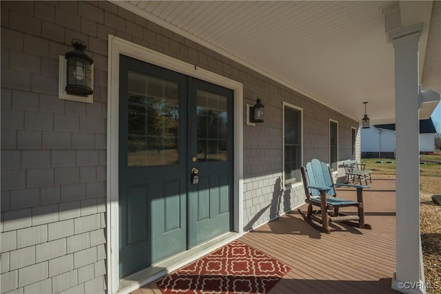 view of exterior entry with covered porch