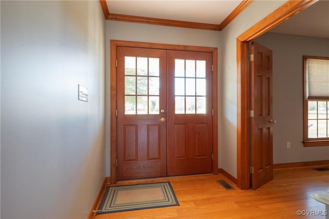 doorway with light hardwood / wood-style flooring and ornamental molding