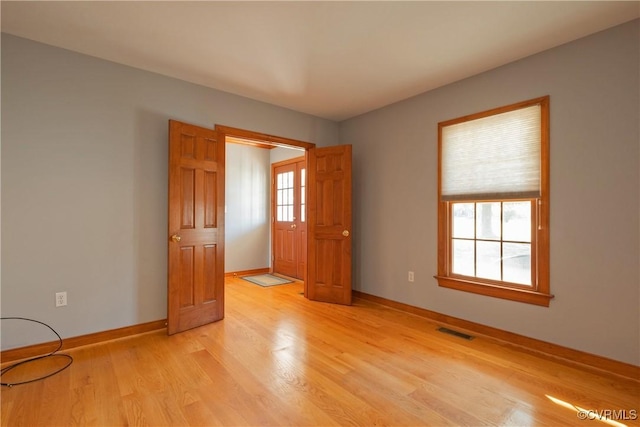 spare room with light wood-type flooring