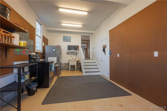 garage with stainless steel fridge