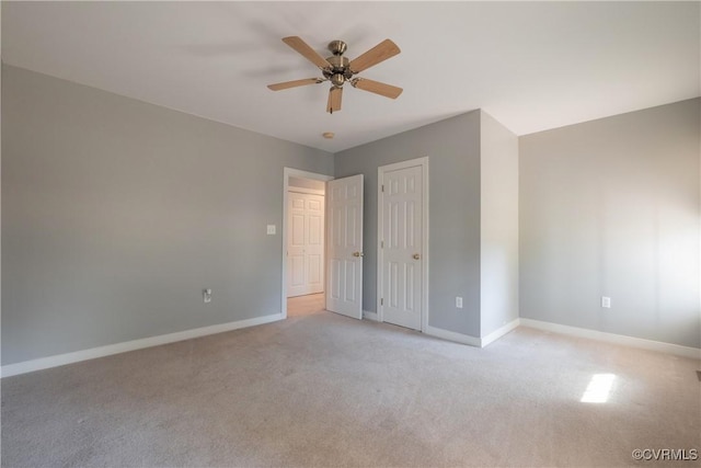 unfurnished bedroom with ceiling fan and light carpet