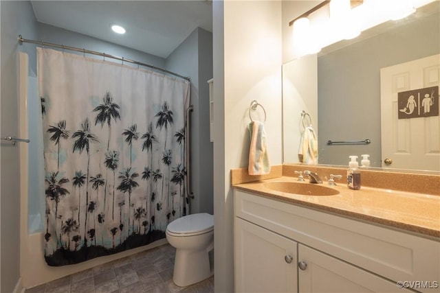 bathroom featuring curtained shower, vanity, and toilet