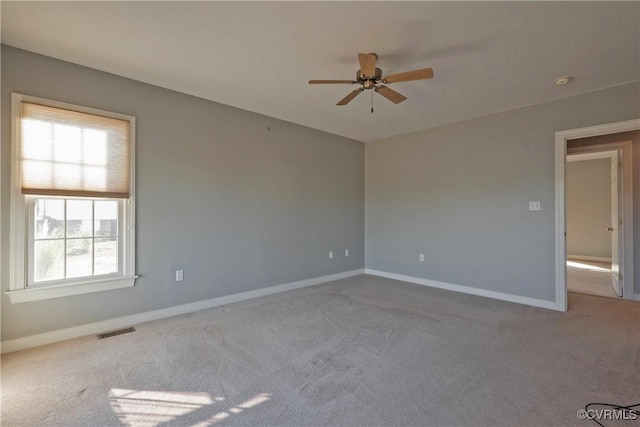 unfurnished room with ceiling fan and light carpet