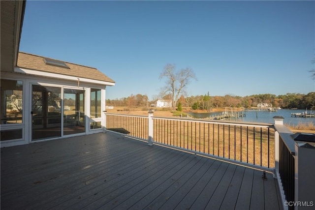 wooden deck with a water view and a sunroom