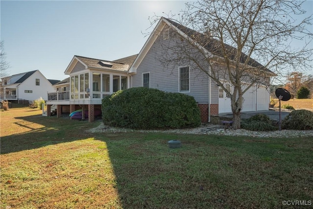 exterior space with a sunroom, a garage, and a front lawn