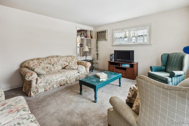 carpeted living room featuring an AC wall unit