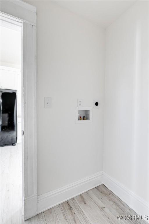 laundry area with hookup for a washing machine and light hardwood / wood-style flooring