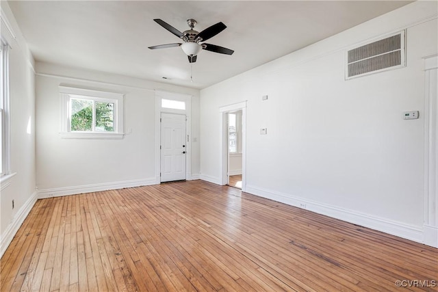 empty room featuring ceiling fan and light hardwood / wood-style flooring