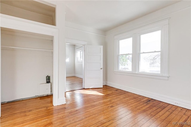 unfurnished bedroom featuring light wood-type flooring and a closet