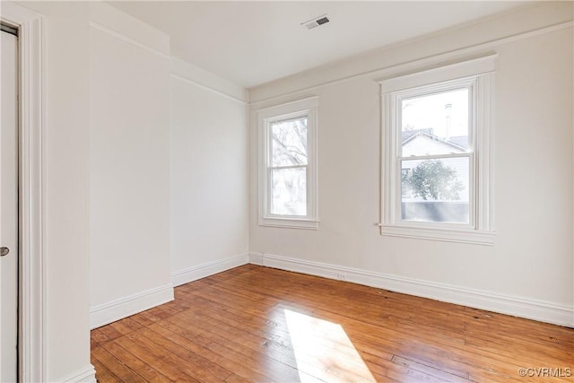 unfurnished room with hardwood / wood-style floors