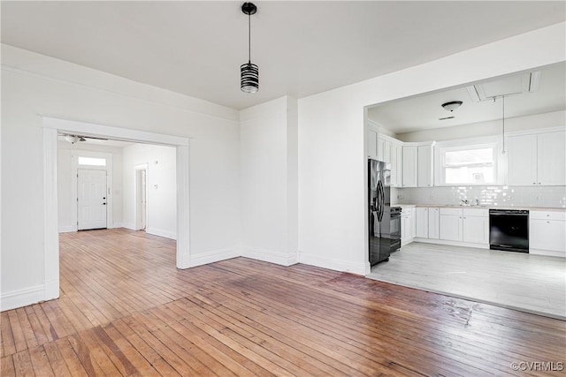 interior space with ceiling fan, light hardwood / wood-style flooring, and sink