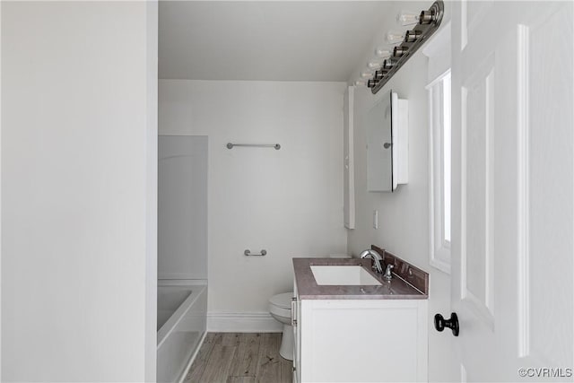 full bathroom featuring vanity, toilet, wood-type flooring, and shower / washtub combination