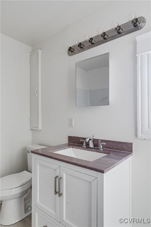 bathroom featuring vanity and toilet