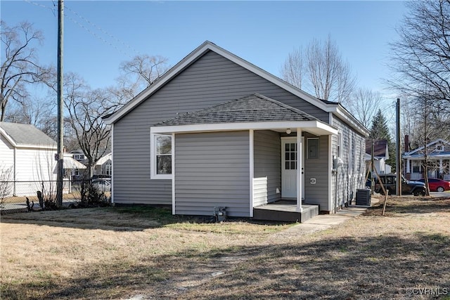 back of property featuring a yard and cooling unit