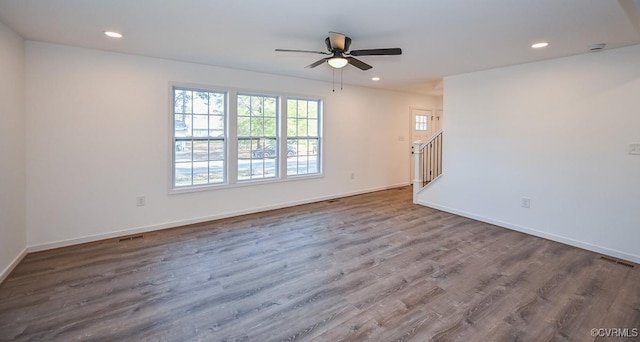 spare room featuring hardwood / wood-style flooring and ceiling fan