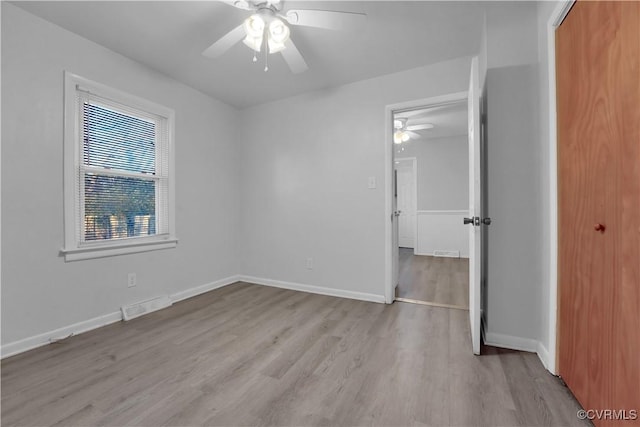 unfurnished bedroom featuring ceiling fan, light hardwood / wood-style floors, and a closet