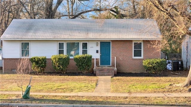 view of front of property with a front lawn and cooling unit