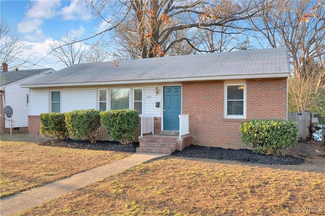 ranch-style home with a front lawn