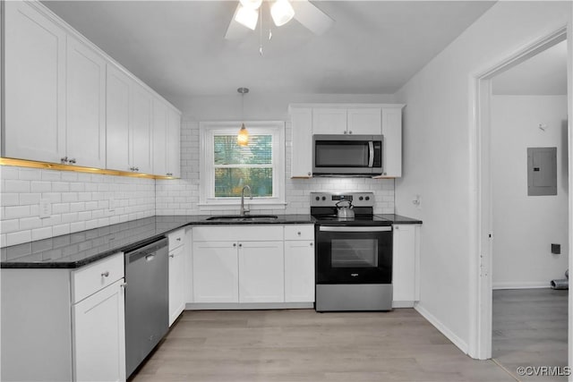 kitchen featuring white cabinets, pendant lighting, appliances with stainless steel finishes, and sink