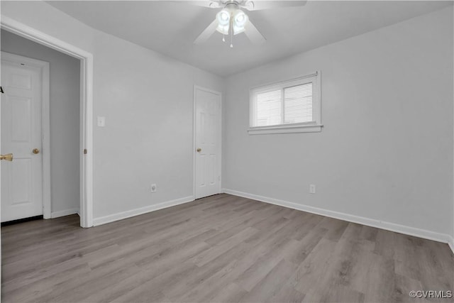 spare room with light hardwood / wood-style floors and ceiling fan