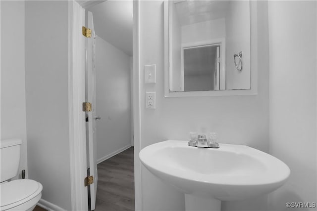 bathroom featuring hardwood / wood-style flooring, sink, and toilet