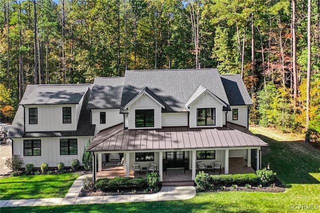 modern inspired farmhouse featuring a front yard and a porch