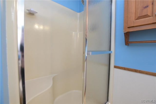 bathroom with a shower with shower door