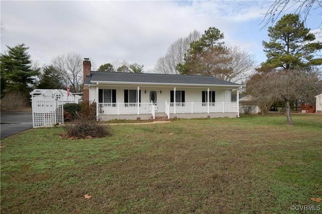 ranch-style home with covered porch and a front lawn