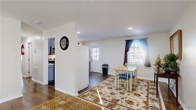 dining space with dark wood-type flooring