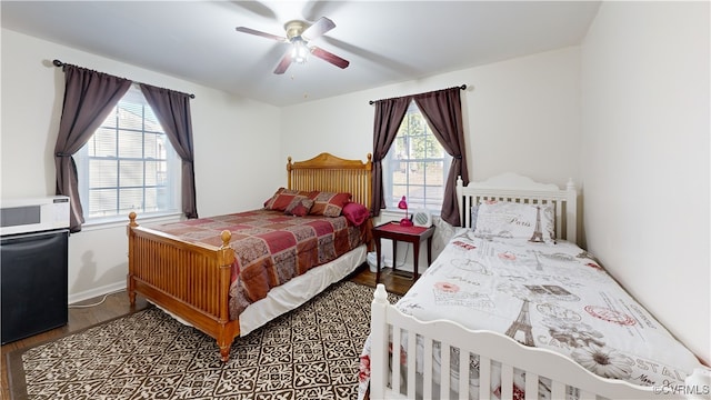 bedroom with hardwood / wood-style floors and ceiling fan