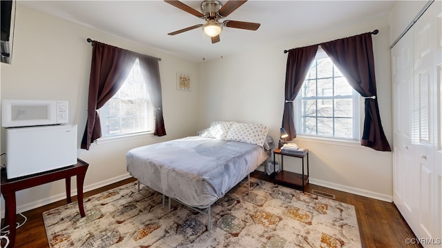 bedroom featuring ceiling fan and dark hardwood / wood-style flooring