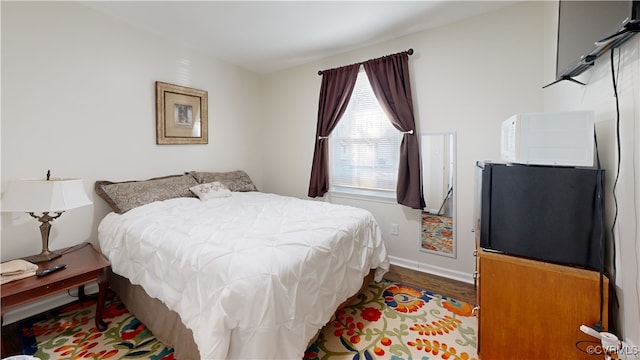 bedroom with hardwood / wood-style flooring