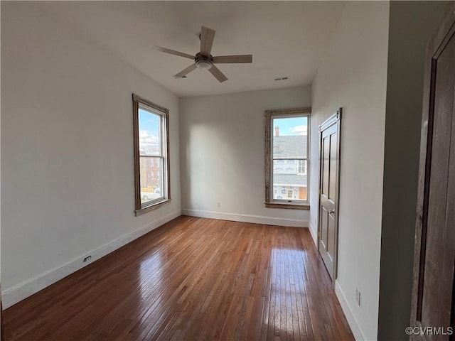 empty room with ceiling fan and wood-type flooring