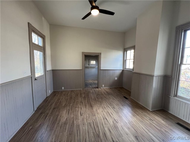 interior space featuring wood-type flooring, plenty of natural light, and ceiling fan