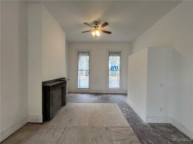 unfurnished living room with ceiling fan