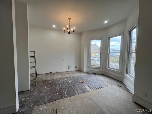 unfurnished dining area with a notable chandelier