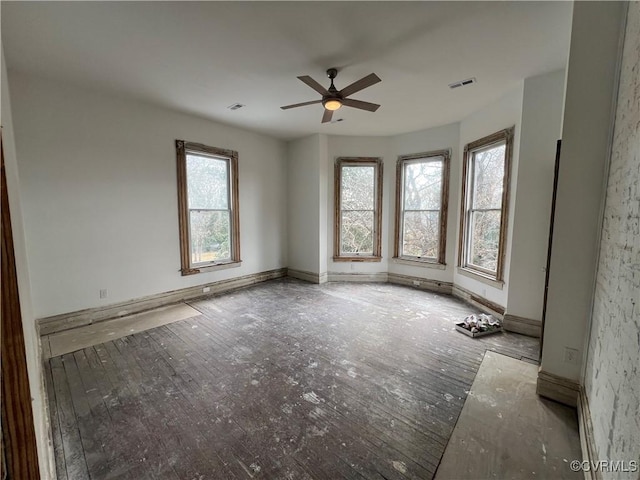 unfurnished room featuring ceiling fan and a healthy amount of sunlight