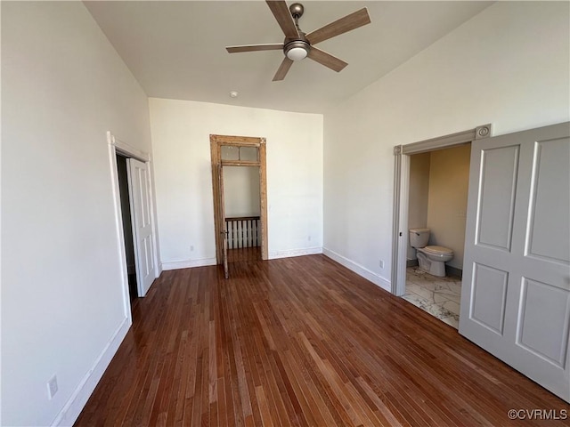 unfurnished bedroom featuring ceiling fan, dark hardwood / wood-style floors, and ensuite bath