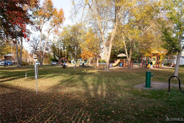 view of home's community featuring a playground and a lawn