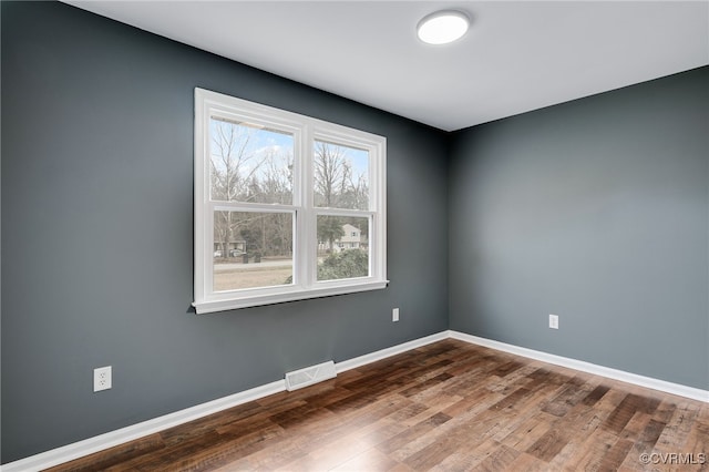 spare room featuring hardwood / wood-style flooring