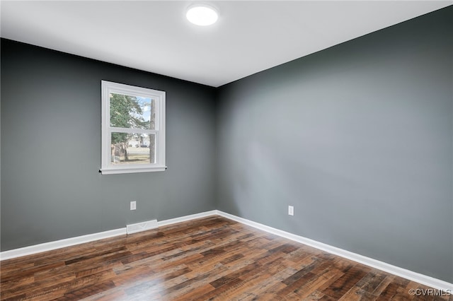 spare room with dark hardwood / wood-style flooring