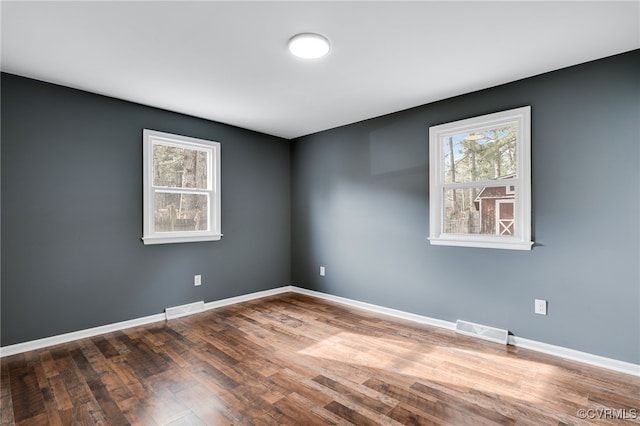 empty room featuring wood-type flooring