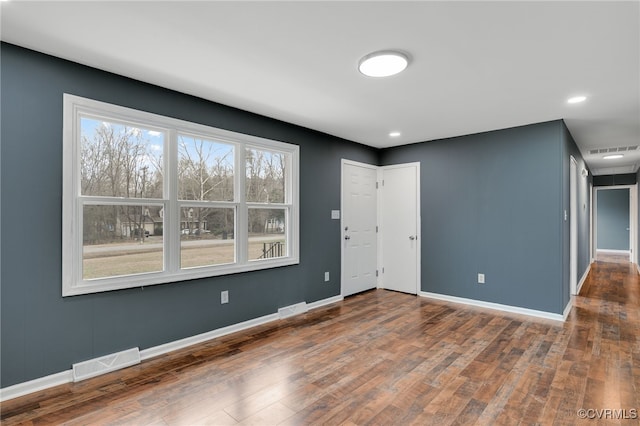 unfurnished room featuring dark wood-type flooring